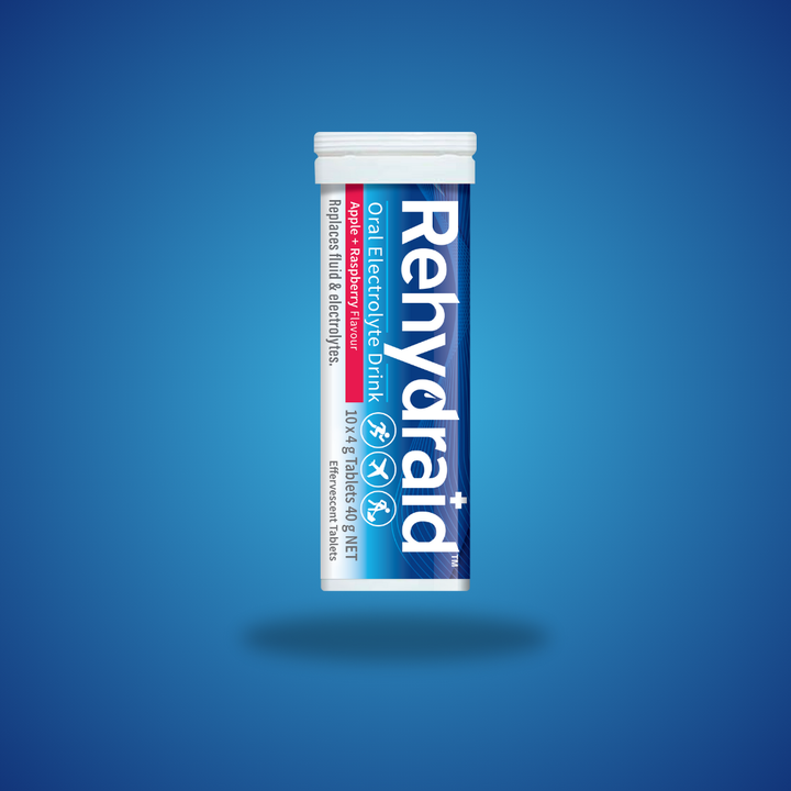 Rehydraid Oral Electrolyte Drink tube containing 10 effervescent tablets in apple and raspberry flavor. The tube indicates it replaces fluid and electrolytes, with symbols showing it is suitable for physical activity and travel.